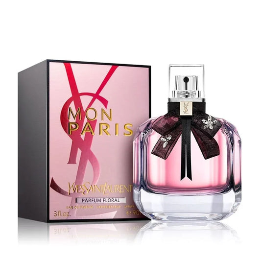 Mon Paris By Yves Saint Laurent bottle with box on a plain background
