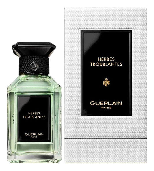 Bottle of Guerlain Herbes Troublantes shown next to its packaging