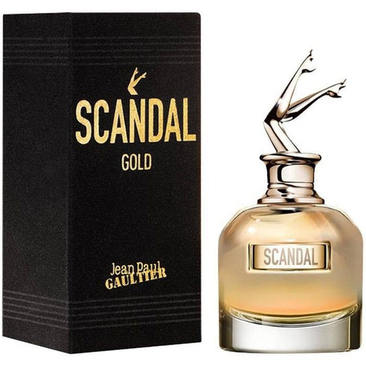 Jean Paul Gaultier Gold bottle with box on a plain background